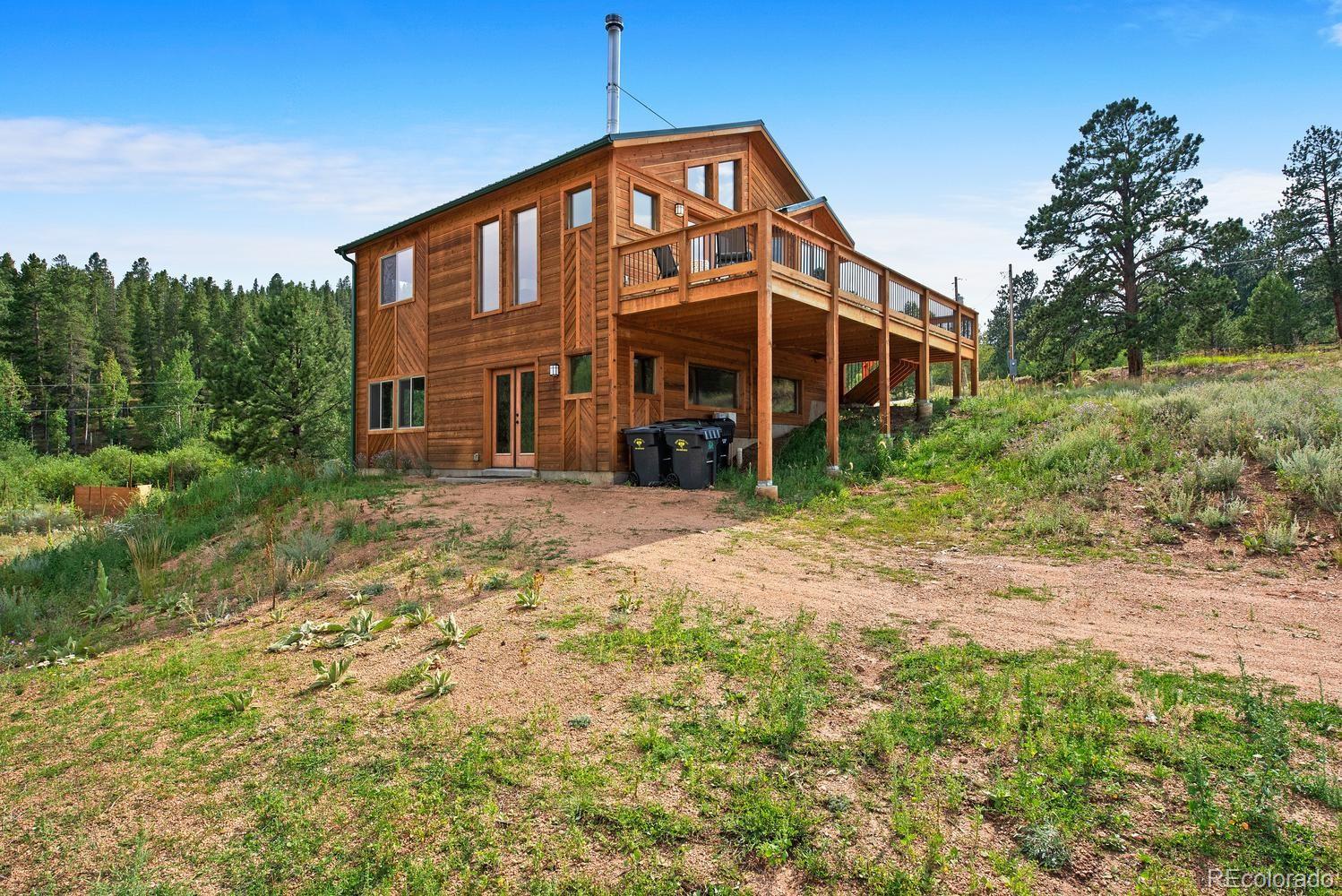 1328 Clark Road Bailey, CO 80421 - Photo 34 of 37 a front view of a house with a yard