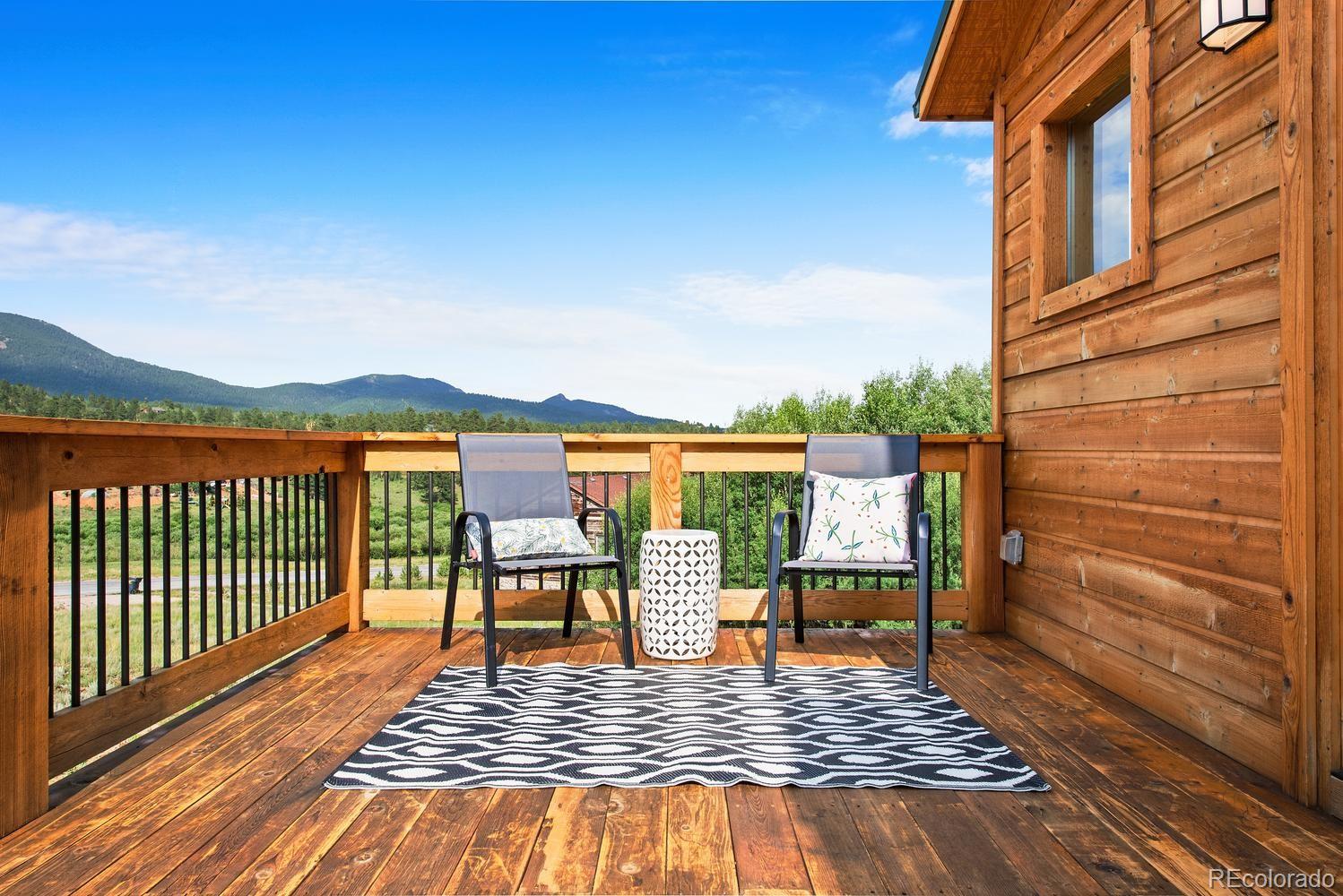 1328 Clark Road Bailey, CO 80421 - Photo 7 of 37 a view of a roof deck with wooden floor and city view