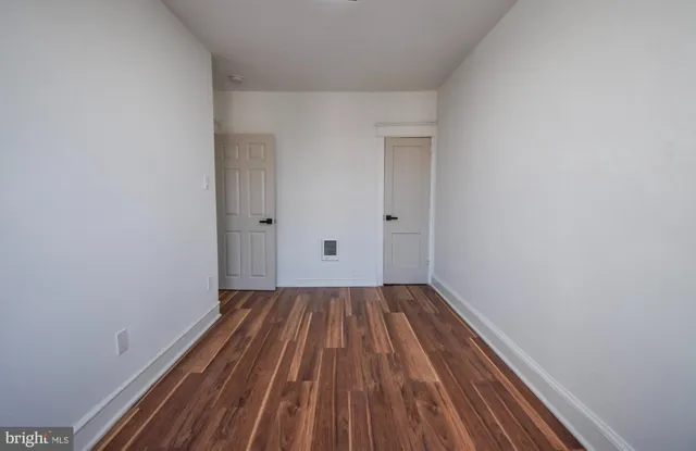 a view of a room with wooden floor