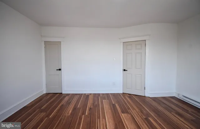 a view of a room with wooden floor