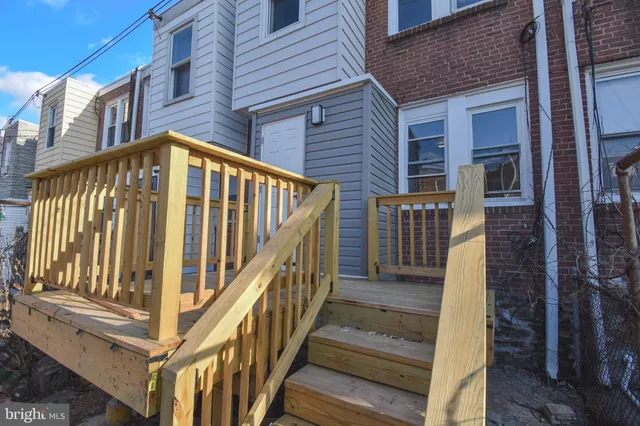 a view of a house with wooden fence