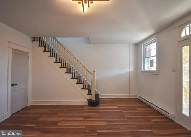 a view of entryway and hall with wooden floor