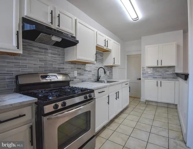 a kitchen with cabinets stainless steel appliances and a sink