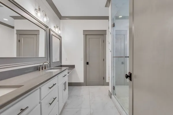 a spacious bathroom with a granite countertop sink mirror and double