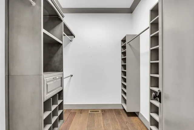 a view of walk in closet with empty racks