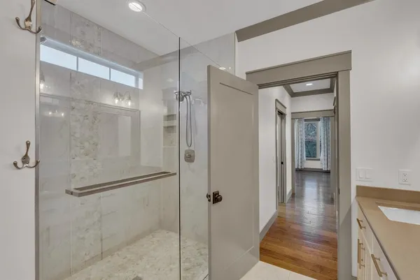 a bathroom with a glass shower door