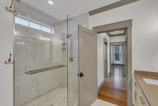 a bathroom with a glass shower door