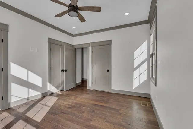 a bathroom with a sink a toilet a mirror a vanity and shower