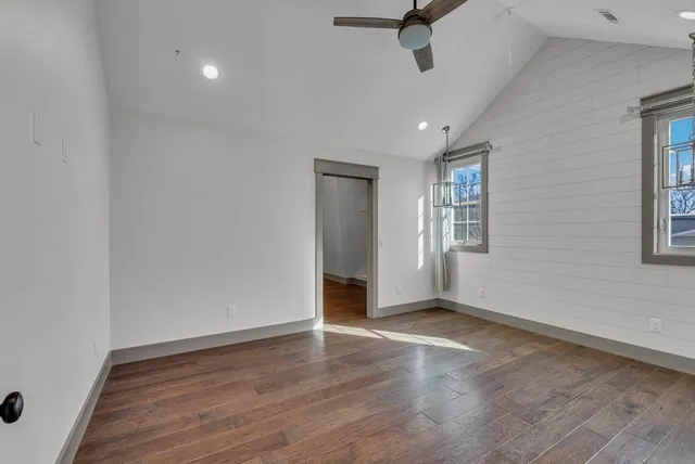 a bathroom with a toilet a sink a mirror a bathtub and vanity