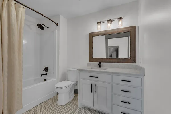 a view of a hallway with wooden floor and stairs