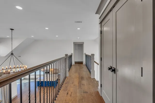 wooden floor in an empty room with a ceiling fan