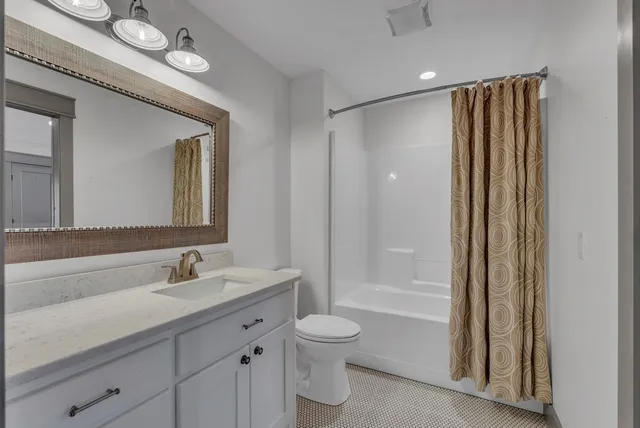 a view of empty room with wooden floor and entryway