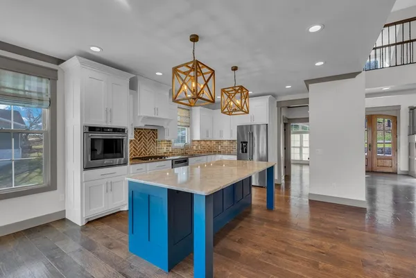 a kitchen with a sink appliances and cabinets