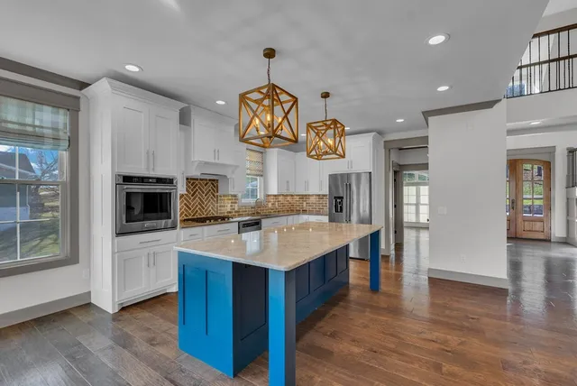 a kitchen with a sink appliances and cabinets