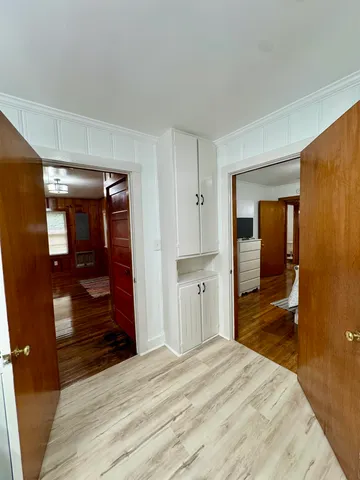a bedroom with furniture and large windows