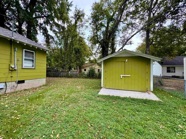 a view of small pool with a table and chairs under an umbrella