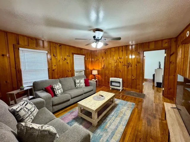 a living room with furniture and a chandelier