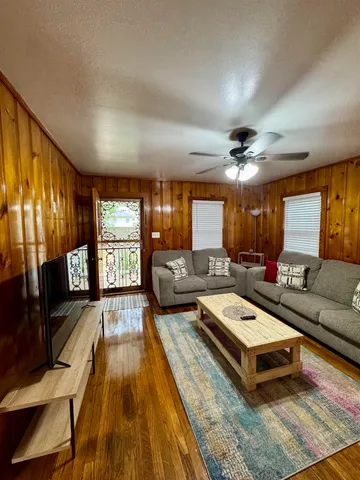 a living room with furniture fireplace and flat screen tv