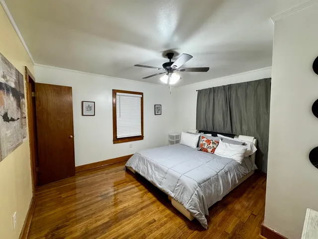 a bedroom with a large bed and a chandelier