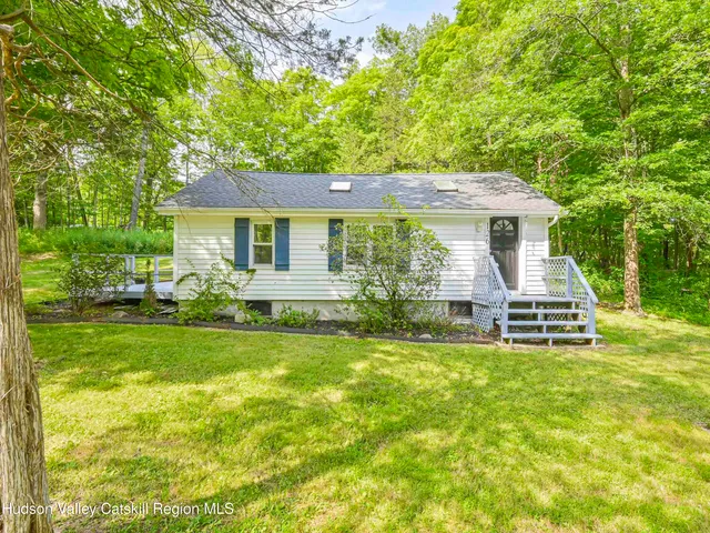 a view of a house with a yard porch and sitting area