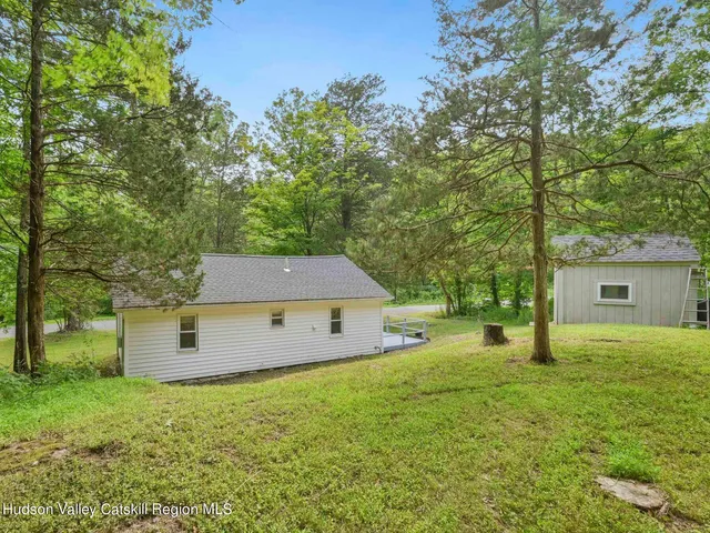 a backyard of a house with yard and trampoline