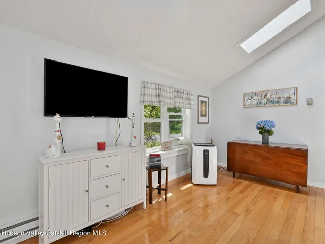 a view of a workspace with furniture and a flat screen tv