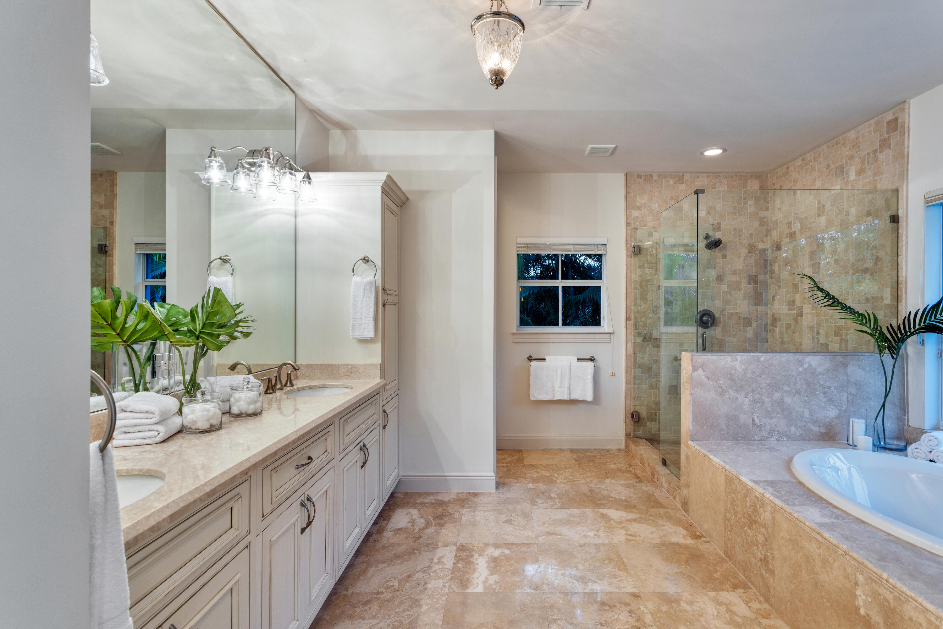 391 East Boca Raton Road Boca Raton, FL 33432 - Photo 17 of 26 a spacious bathroom with a double vanity sink a large mirror and a shower