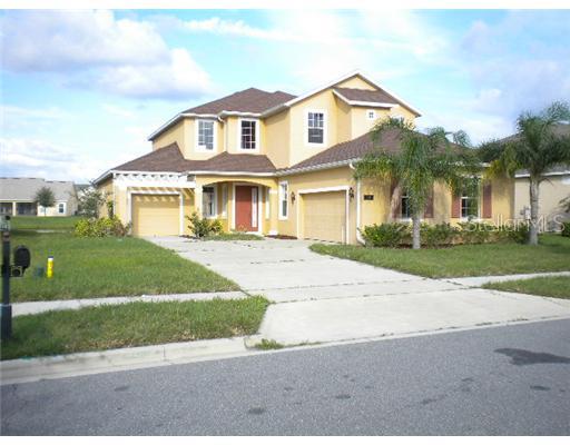 4425 Indian Deer Road Windermere, FL 34786 - Photo 1 of 1 a front view of a house with a garden and trees