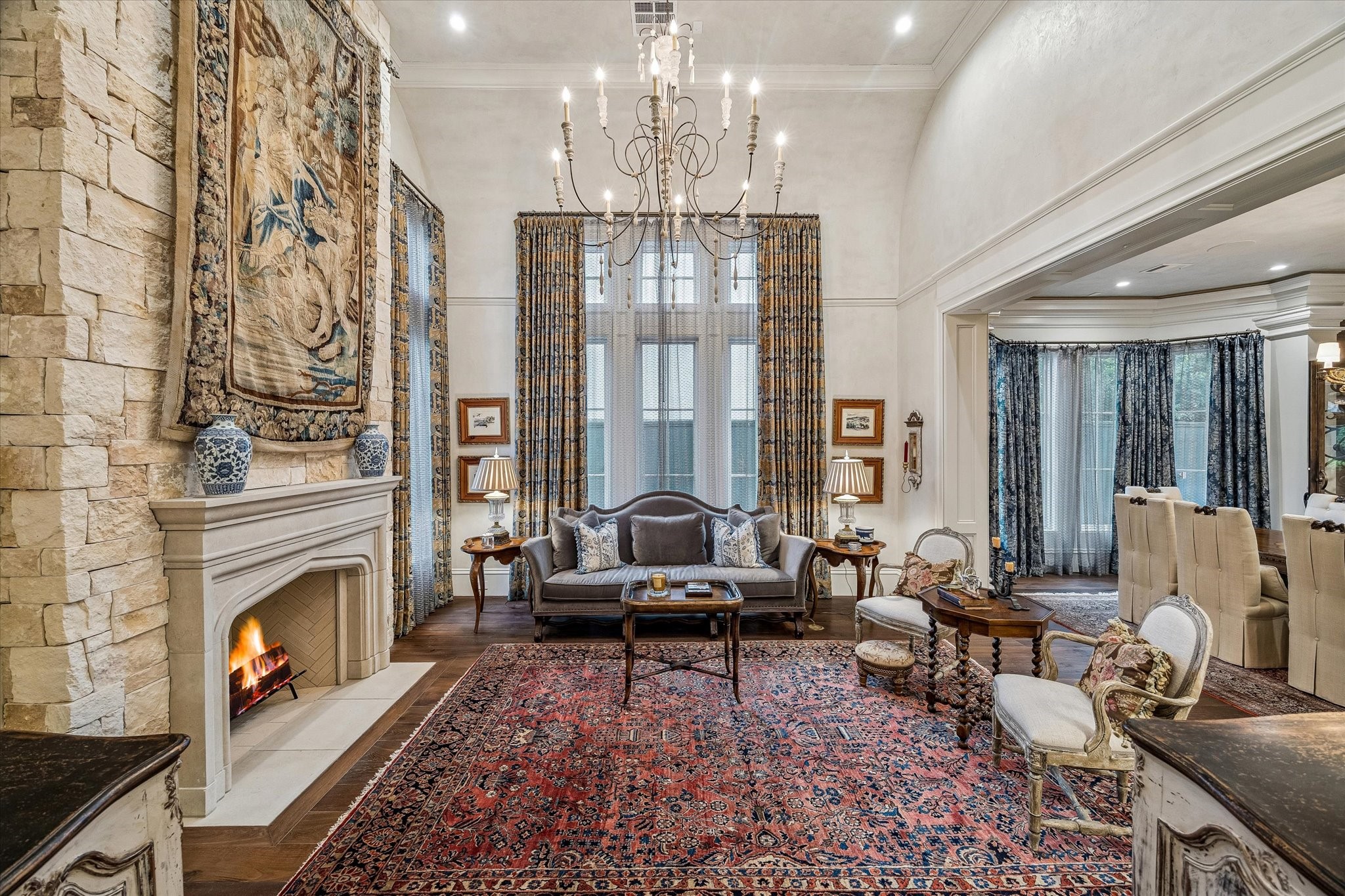 2158 Chilton Road Houston, TX 77019 - Photo 11 of 50 Refined and airy, the formal living room showcases exquisite Segreto plaster finishes and a limestone-clad fireplace. Open to the foyer and dining room, it offers a seamless flow for elevated entertaining.