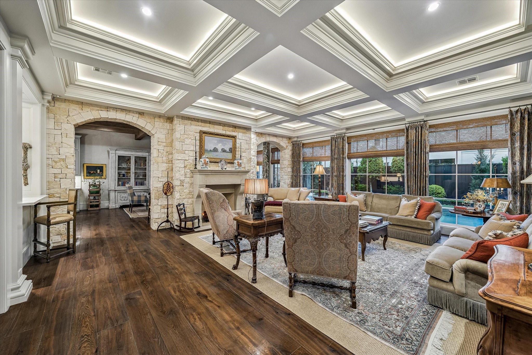 2158 Chilton Road Houston, TX 77019 - Photo 15 of 50 Designed for both comfort and entertaining, the family room offers generous scale, custom finishes, and seamless flow to the kitchen, wet bar, and breakfast room. Expansive windows create a bright, airy ambiance overlooking the backyard.