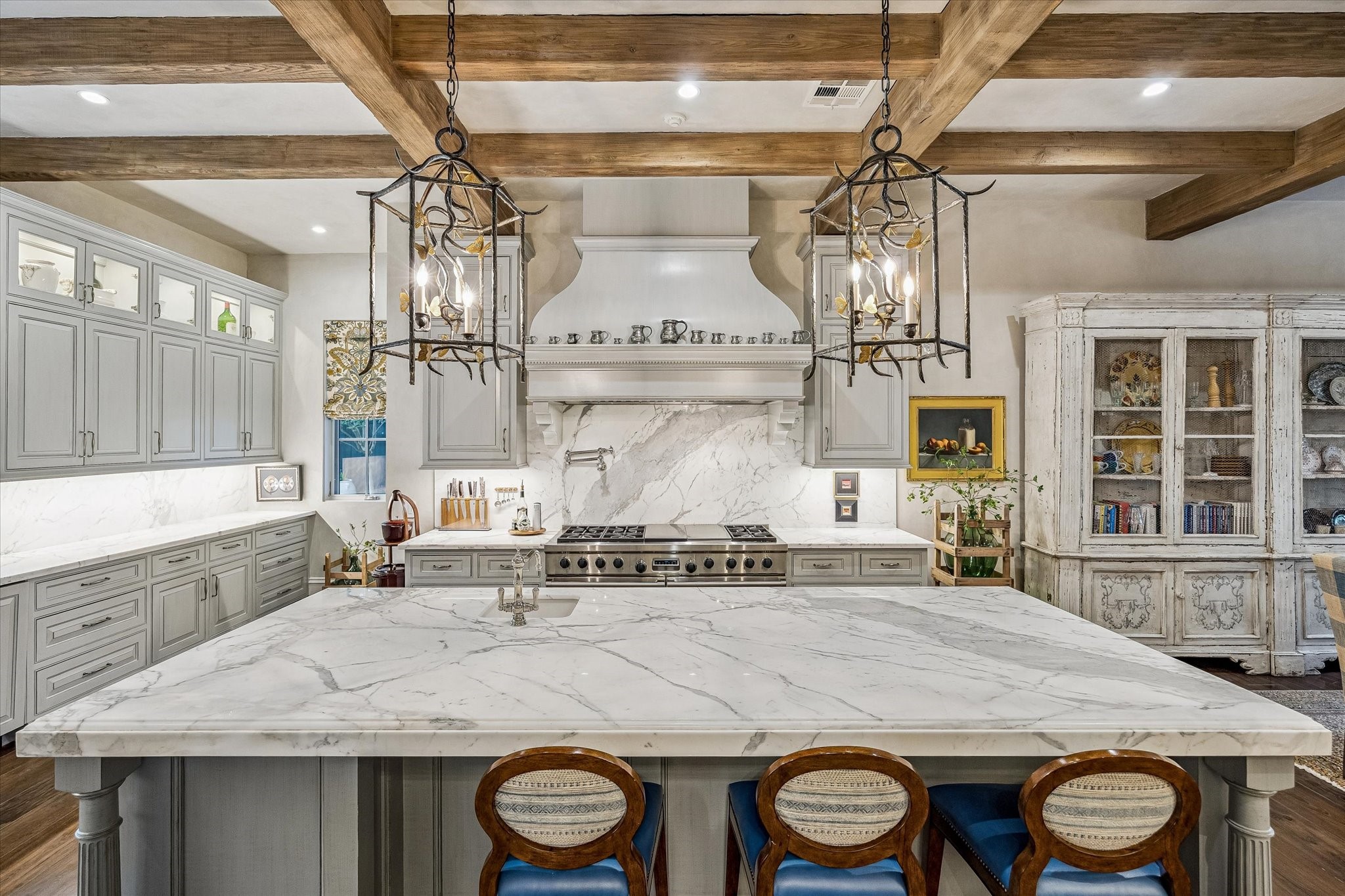 2158 Chilton Road Houston, TX 77019 - Photo 19 of 50 A refined culinary space equipped with SubZero, Wolf, and Bosch appliances, complemented by custom millwork and luxurious materials. The open layout, breakfast bar, and built-in office niche enhance both functionality and flow.