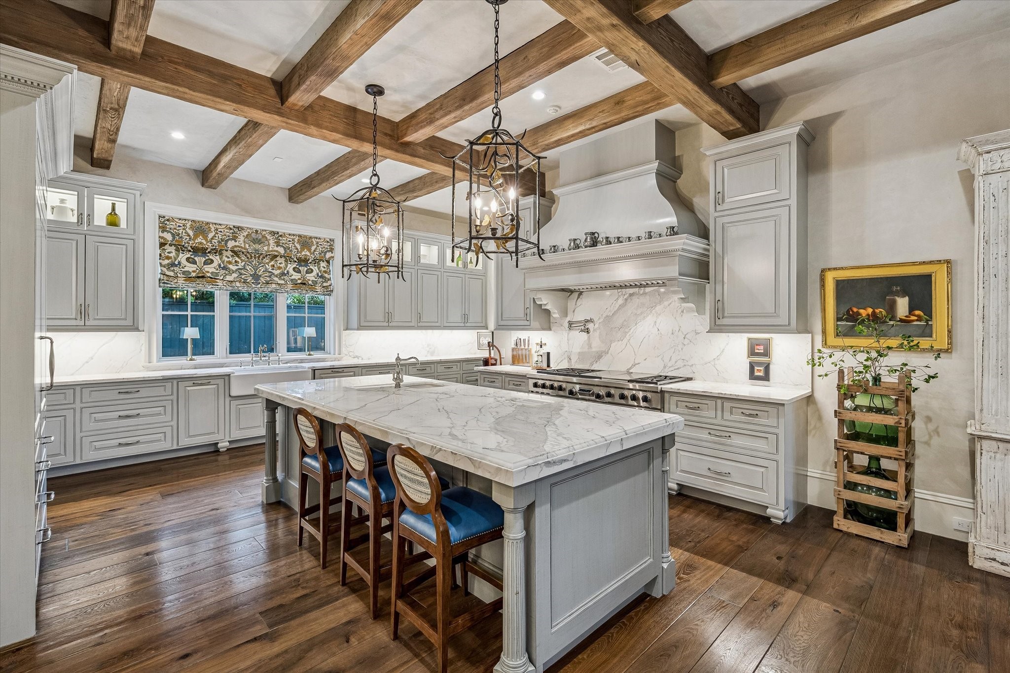 2158 Chilton Road Houston, TX 77019 - Photo 20 of 50 Thoughtfully designed for everyday living, the kitchen boasts top-tier appliances, a spacious marble island, and a walk-in pantry. Elegant finishes and a beamed ceiling elevate the space with timeless sophistication.
