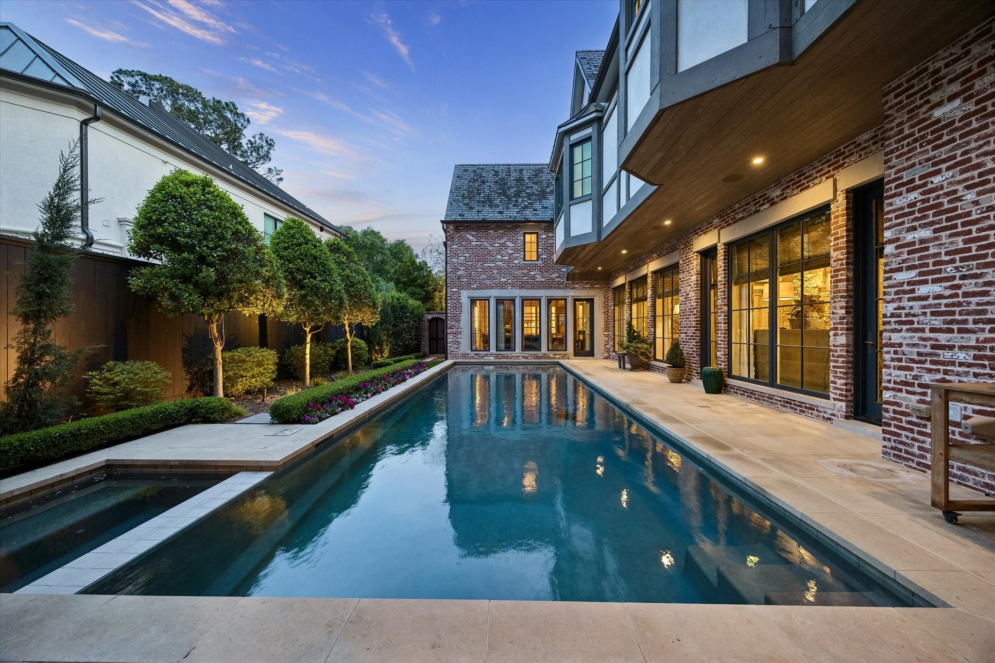 2158 Chilton Road Houston, TX 77019 - Photo 25 of 50 The sparkling pool and spa, complete with a heater and outdoor shower, create a resort-style backyard retreat. Lush landscaping, landscape lighting, and hand-laid brick hardscaping enhance both beauty and functionality.