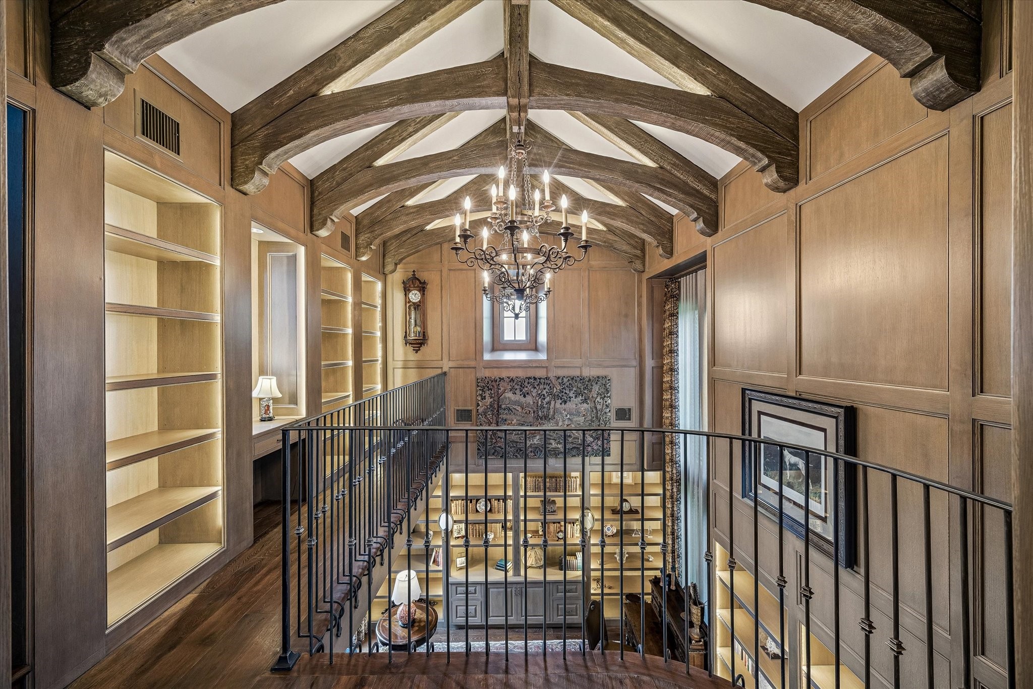 2158 Chilton Road Houston, TX 77019 - Photo 30 of 50 The second-floor library features custom built-in bookshelves with backlighting, perfectly combining style and function. This elegant display offers ample storage while enhancing the room’s sophisticated, light-filled ambiance.
