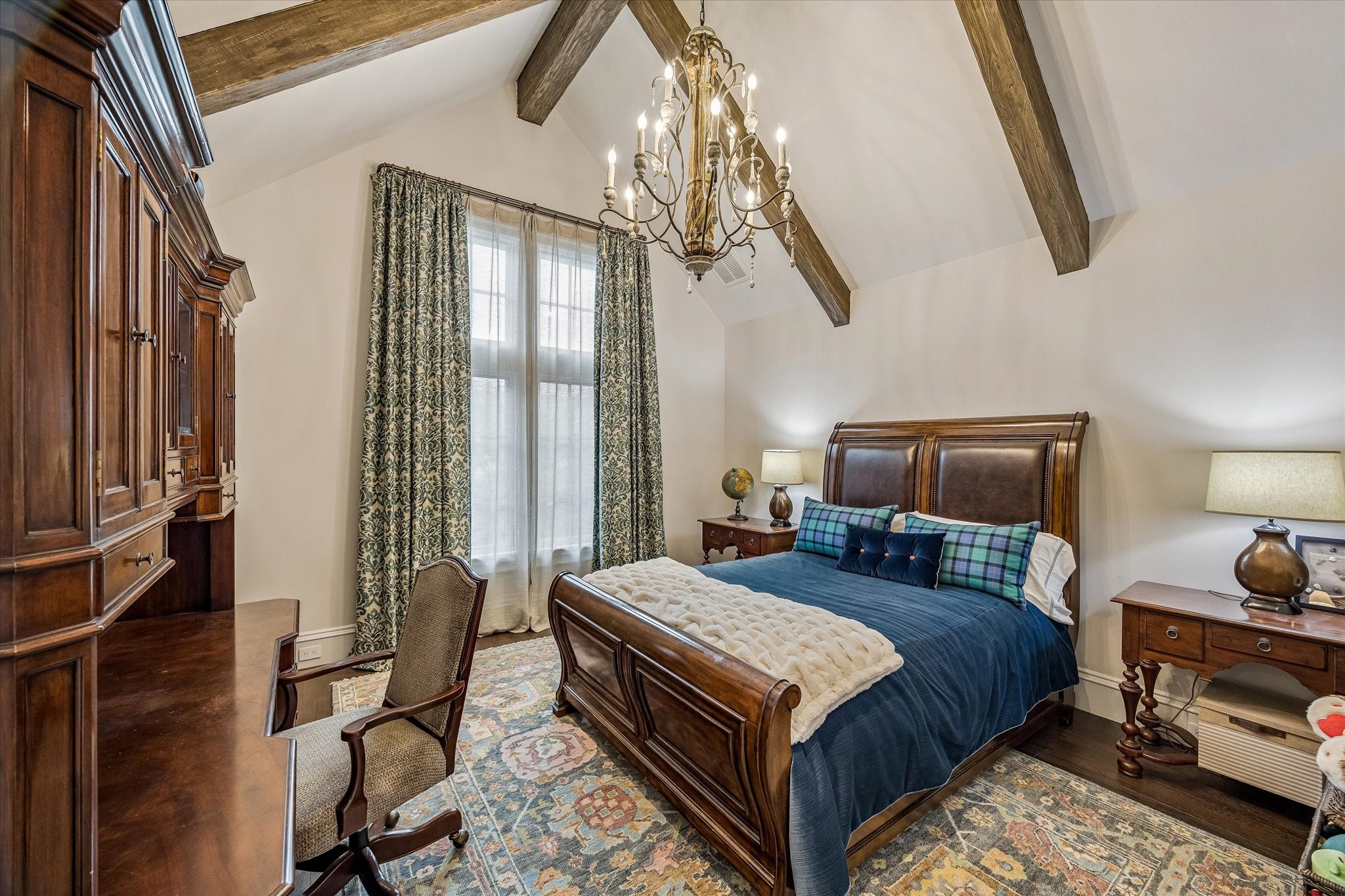 2158 Chilton Road Houston, TX 77019 - Photo 36 of 50 Guest Bedroom No. 1 offers vaulted ceilings with wood beams, western-facing windows, and custom treatments. Hardwood floors and designer lighting create a bright and inviting retreat with an en-suite bath.