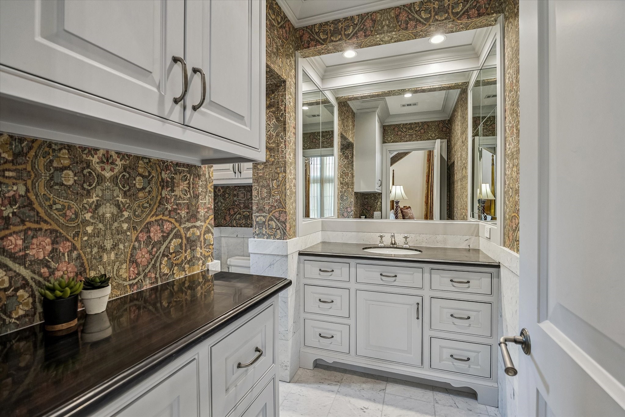 2158 Chilton Road Houston, TX 77019 - Photo 41 of 50 Featuring marble floors and countertops, a walk-in shower with bench seating, and elegant wallcoverings, this ensuite provides both luxury and practicality for guests.