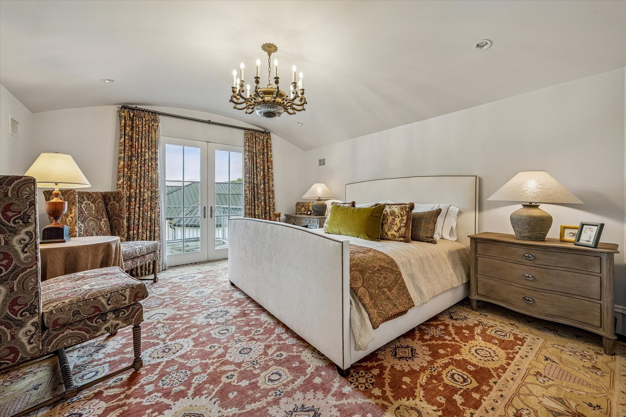 2158 Chilton Road Houston, TX 77019 - Photo 47 of 50 This elegant guest bedroom No. 4 features a barrel ceiling, warm hardwood floors, and designer lighting, creating a serene retreat. Eastern-facing windows and balcony access fill the room with natural light, while custom treatments add a refined touch.