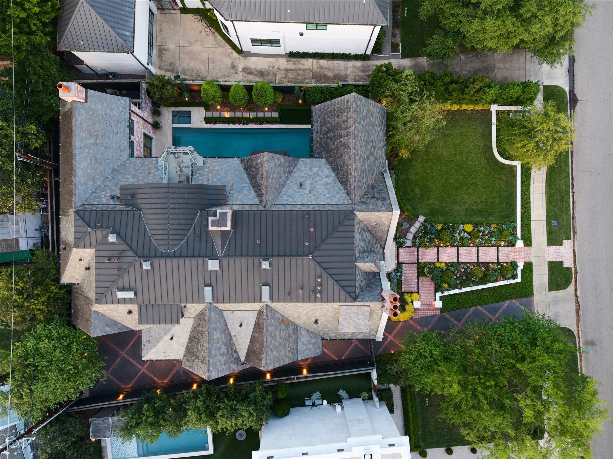 2158 Chilton Road Houston, TX 77019 - Photo 50 of 50 A sweeping aerial view showcases the home’s prime River Oaks location, highlighting the lush front lawn, sparkling pool and spa, manicured landscaping, and elegant architectural details. The property’s generous lot and surrounding greenery create a private and inviting setting.