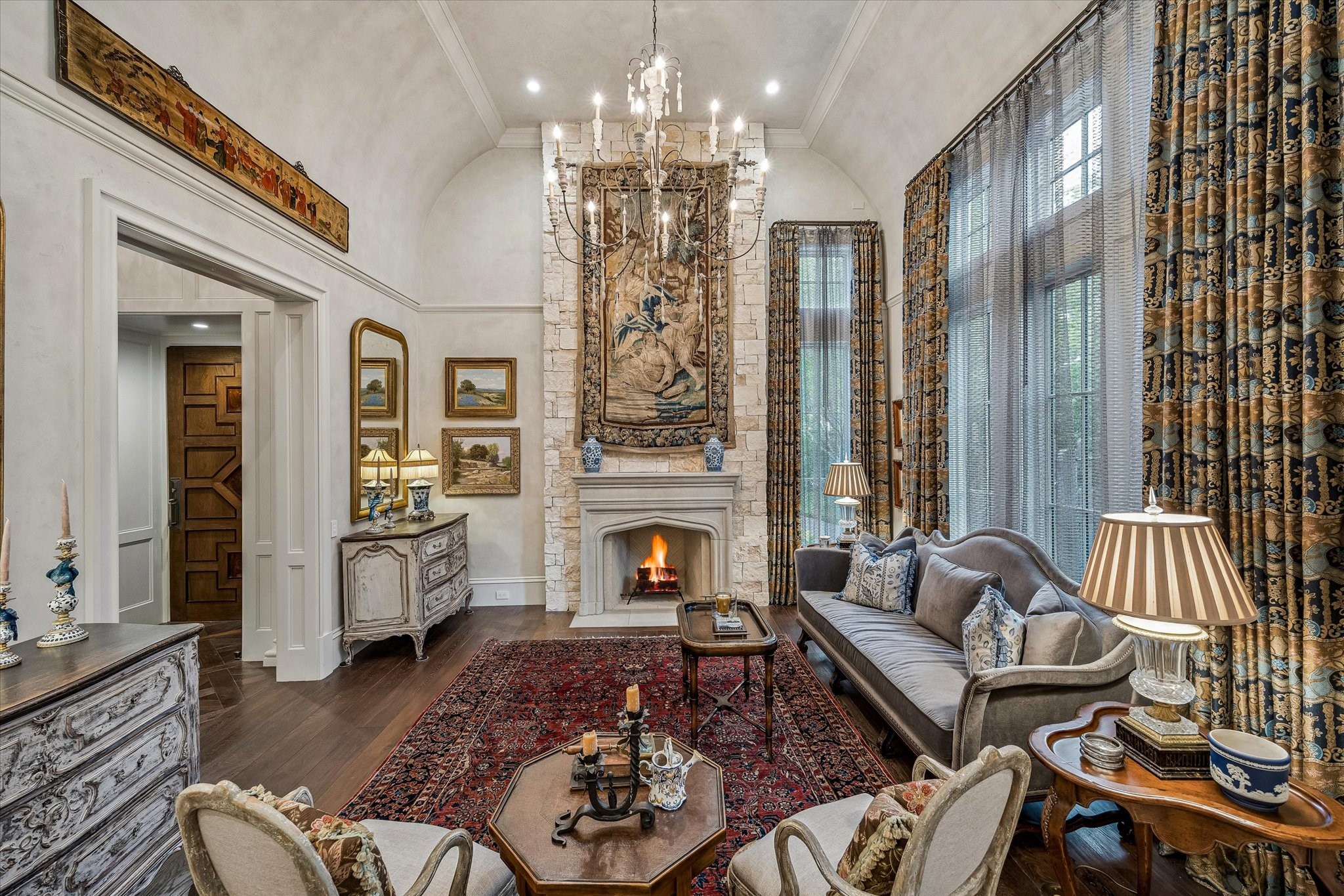 2158 Chilton Road Houston, TX 77019 - Photo 10 of 50 The formal living room exudes timeless elegance with Segreto plaster walls and a beautifully detailed ceiling. A cast stone fireplace anchors the space, while designer lighting and natural light enhance its inviting sophistication.