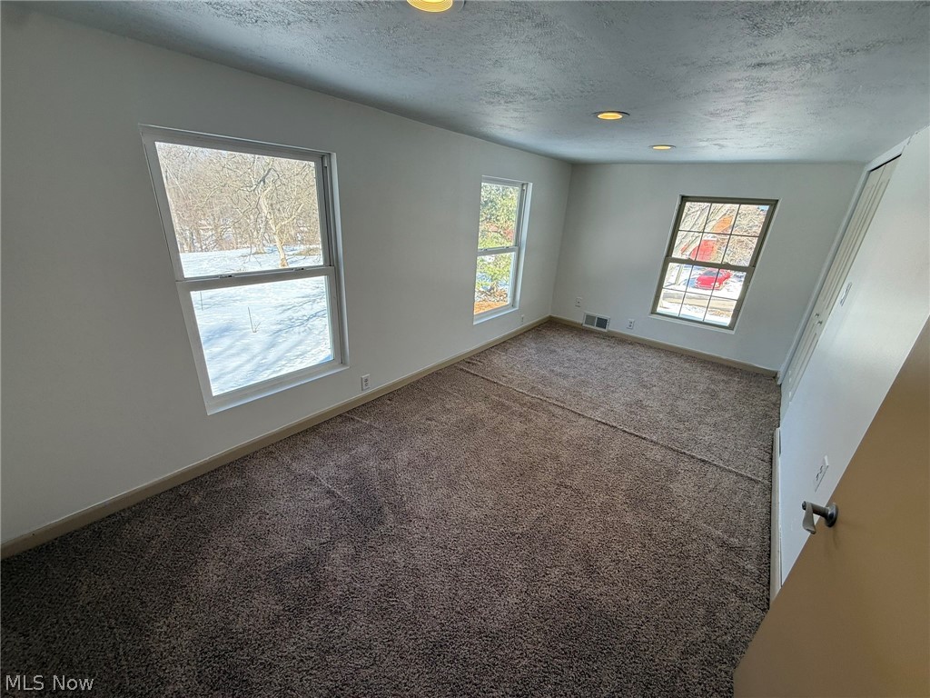 6784 Old Zoarville Road Northeast Dover, OH 44622 - Photo 28 of 50 Spare room featuring carpet floors and a textured ceiling