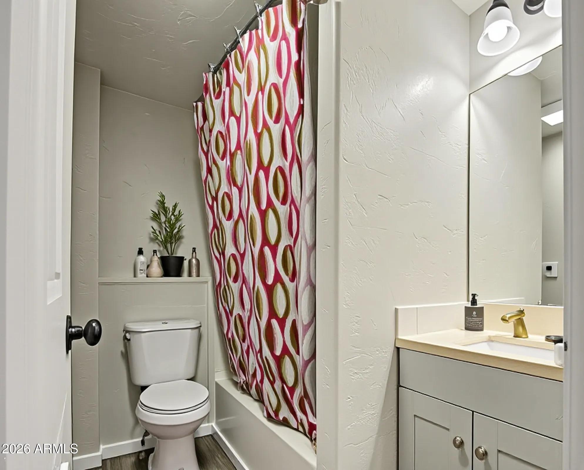 11451 East Broadway Road Mesa, AZ 85208 - Photo 11 of 24 a bathroom with a sink a toilet and a mirror