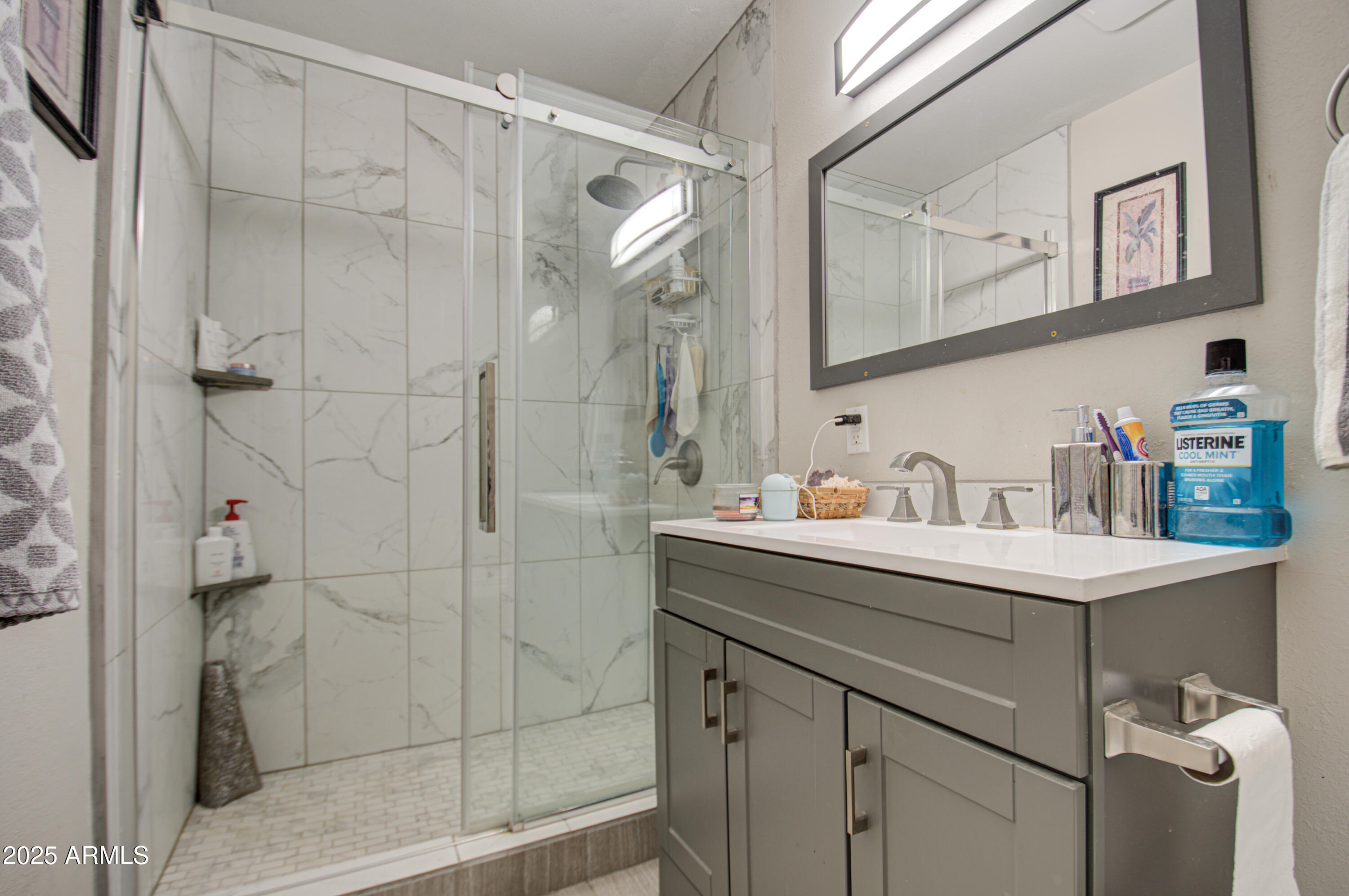 11451 East Broadway Road Mesa, AZ 85208 - Photo 12 of 24 a bathroom with a sink vanity and a shower