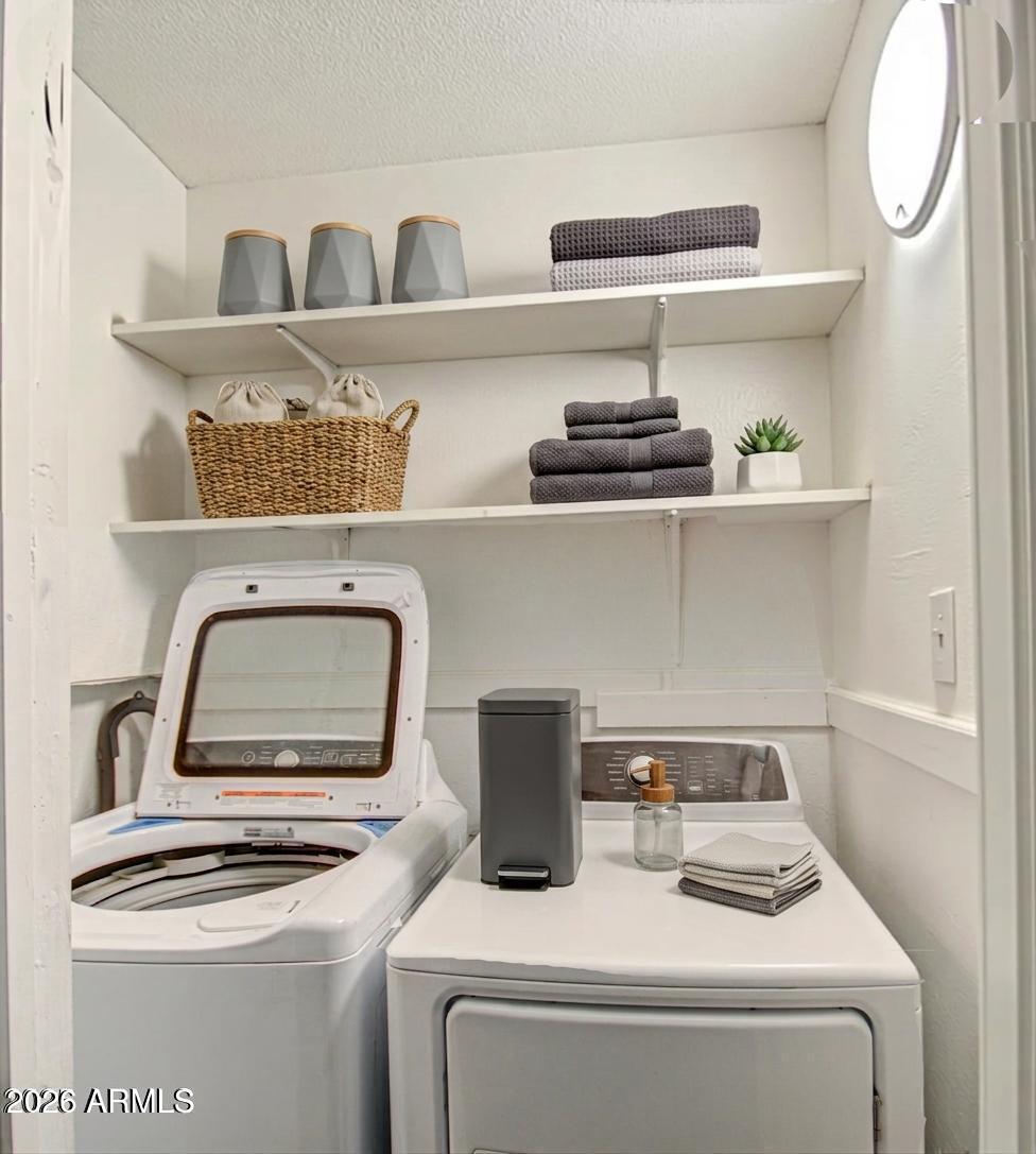 11451 East Broadway Road Mesa, AZ 85208 - Photo 17 of 24 a utility room with dryer washer and empty racks