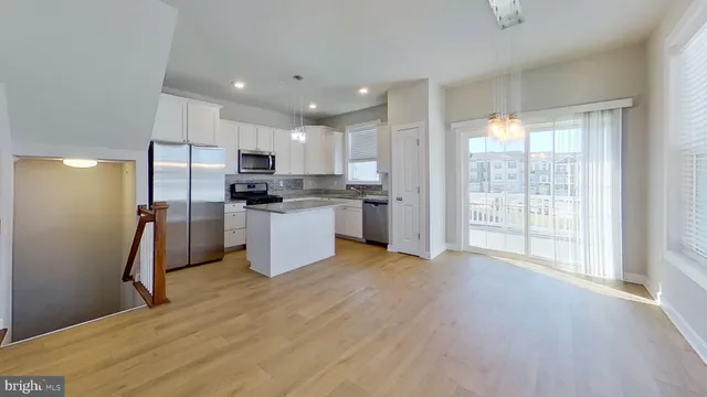 a view of a kitchen with refrigerator and a counter top space