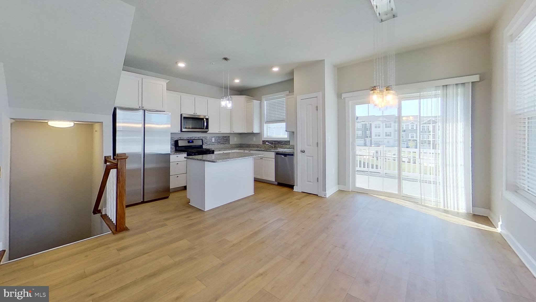 126 Hudson Boulevard Red Lion, PA 17356 - Photo 5 of 15 a kitchen with stainless steel appliances granite countertop a refrigerator a sink dishwasher and a stove with wooden floor