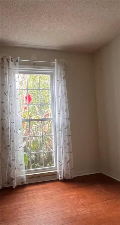 1166 Booth Road Southwest, Unit 908 Marietta, GA 30008 - Photo 11 of 32 a view of empty room with wooden floor and fan