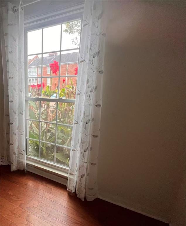 1166 Booth Road Southwest, Unit 908 Marietta, GA 30008 - Photo 12 of 32 an empty room with wooden floor and windows
