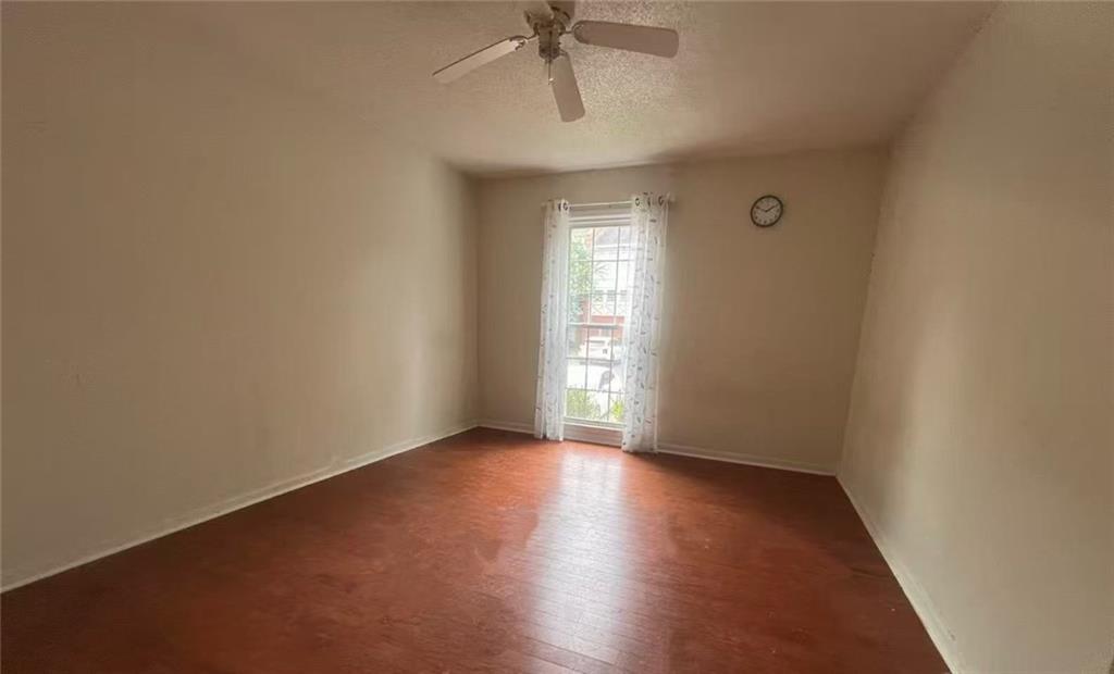 1166 Booth Road Southwest, Unit 908 Marietta, GA 30008 - Photo 15 of 32 an empty room with wooden floor and windows