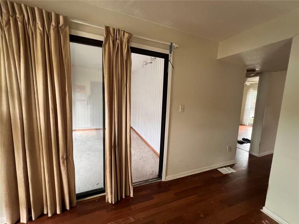 1166 Booth Road Southwest, Unit 908 Marietta, GA 30008 - Photo 21 of 32 an empty room with wooden floor and door