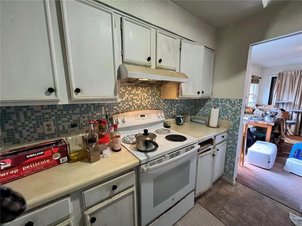 1166 Booth Road Southwest, Unit 908 Marietta, GA 30008 - Photo 26 of 32 a kitchen with a stove and a white cabinets